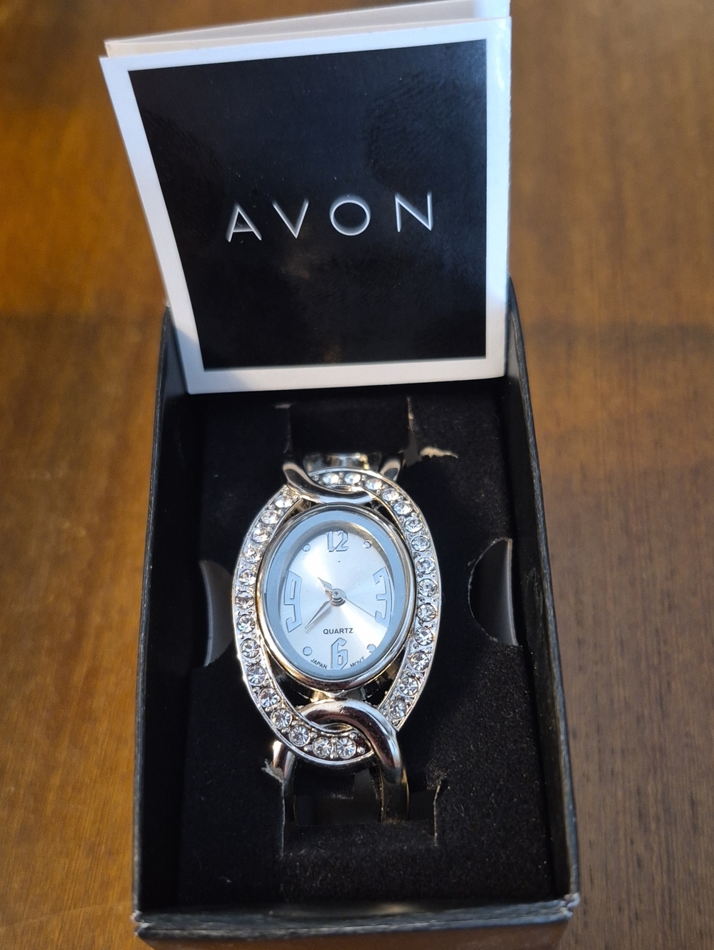 Avon Quartz Silvertone Watch With Hinged Bracelet Oval Face  Rhinestone Accents